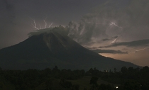 Lightning strikes as Mount Sinabung volcano spews ash and lava at Simpang Empat village Indonesias North Sumatra province on September   