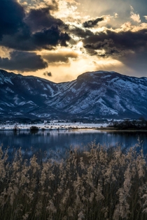 Looking over to Croatia from Bosnia Last sunrays hitting the snow covered Dinaric Alps Lipsko Lake near the town of Livno Bosnia and Herzegovina 