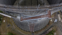 Looking straight down the side of a  cooling tower of an abandoned nuclear power plant
