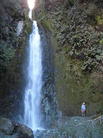 Massive Waterfall in Fiordland National Park New Zealand with myself for size comparison 