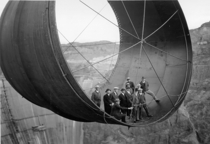 Men stand in a  ton steel pipe over the Hoover Dam  
