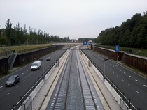 Metro tracks in the median of the Nieuwe Leeuwarderweg s for the future Noord-Zuidlijn  in Amsterdam the Netherlands 