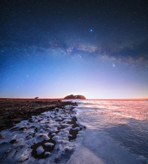 Milky Way fading in the first sunlight over frozen Limfjord Denmark 