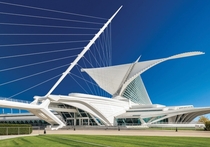Milwaukee Art Museum - Milwaukee WI - The Quadracci Pavilion created by Spanish architect Santiago Calatrava in  contains a movable wing-like brise soleil that opens for a wingspan of  feet  m during the day folding over the tall arched structure at night