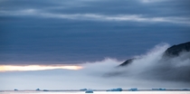 Misty cloudys crashing up against mountains in Thule Region of Avannataa near Siorapaluk Greenland 