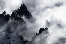 Mountains peaks wrapped in clouds ine the Dolomites 