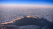 Mt Taranaki New Zealand casting a shadow over the clouds it was holding back this morning 