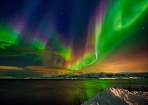 Multi-colored Aurora Borealis and a starry night sky over Troms Norway  by Wayne Pinkston x-post rNorwayPics