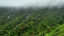 Multiple Waterfalls and clouds coming down in monsoon Mahuli fort India 
