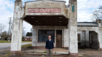 My Grandfather  standing in front of the gas station where he worked his first job