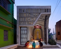 Narayantala Thakurdalan designed by Abin Design Studio is a revived concrete Hindu temple with a glazed corner that opens onto the street in Bansberia of West Bengal in India