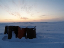 Oil barrels in the frozen wilderness Inuvik Region NT Canada 