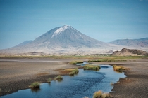Ol Doinyo Lengai the Mountain of God from the south shore of Lake Natron 