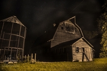 Old abandoned farm on a starry night in Iowa 