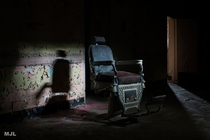 one of a kind  year old barber chair in abandoned psychiatric hospital 
