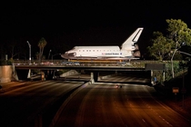 One year ago today Interstate  is shut down temporarily as the Space Shuttle Endeavour Orbiter crosses the Manchester Blvd overpass on its way to its final home at the California Science Center museum - Los Angeles CA 