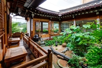 Open courtyard and garden of a tea house in the historic Bukchon Hanok Village Jongno District Seoul South Korea 