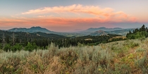 Panorama of colorful clouds arching perfectly over a valley in the Portneuf Range in SE Idaho USA 