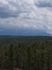 Pikes peak in Colorado from a distance with a storm over the peak OC