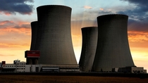 Quad hyperbolic cooling towers at a huge electric power plant during a lovely sunset 