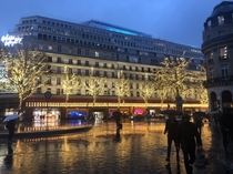 Rainy dawn behind Palais Garnier looking at Galeries Lafayette in Paris