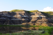 Randomly placed amongst hours of completely flat grasslands is this valley Many dinosaurs have first been discovered here and this area remains a hotbed for dinosaur fossils Drumheller Alberta Canada 
