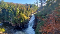 Rapids flowing through a serene autumn forest in Quebec Canada 