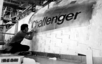 Rockwell International worker painting Challengers name on the starboard side of her forward fuselage just prior to roll-out in  