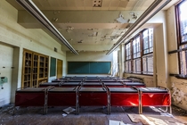 Rows of red desks in an abandoned Detroit high school 