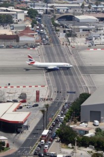 Runway at Gibraltar International Airport Intersecting main road must be closed whilst runway is in use 