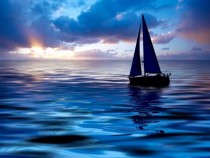 Sailboat on the ocean mixes with the sky 