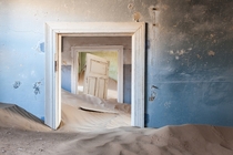 Sand filled house from the ghost town of Kolmanskop Namibia Africa 