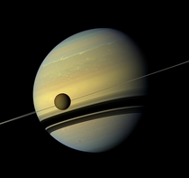 Saturn and its largest moon reflect their true colors 