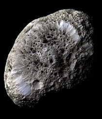 Saturns moon Hyperion resembles a large sponge traveling through space