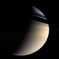 Saturns rings are viewed edge-on by Cassini with the rings shadows cast against Saturns clouds Ice moon Enceladus makes a cameo 