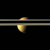 Saturns rings obscure part of Titans colorful visage in this image from NASAs Cassini spacecraft The south polar vortex that first appeared in Titans atmosphere in  is visible at the bottom of this view