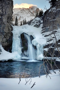 Saw cougar tracks in the snow on the way to this half frozen waterfall Just another day in the Rocky Mountains of Alberta 