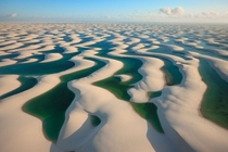 Seen from the air the dunes look like white linens hung out to dry on a windy afternoon Lenis Maranhenses Brazil Photograph by George Steinmetz 
