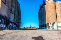 Shot of the Chicago skyline thru the gap of the abandoned Damen Silos in the foreground 