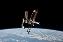 Shuttle docked with ISS and Earth in the background 