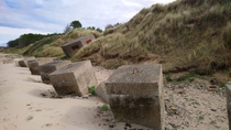 Slowly deteriorating WW coastal defence installations on a beach on Scotlands Moray Coast 