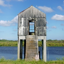 Small pump house on a canal by Lake Okeechobee Florida  album in comments with mechanical pump bone pile and landscape setting