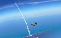 Space Shuttle Launches Behind an F- 
