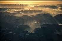 Streaks of sunlight shine over the Himalayas at dawn  by Nutthavood Punpeng