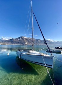 stunning midday shot of the crystal clear Lake Annecy tucked away in Eastern France 
