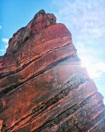 Sun peeking from behind Red Rocks in Colorado -- OC