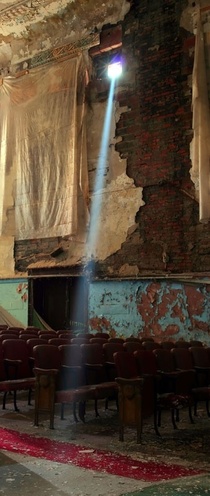 Sunlight streams through a broken window in an old vaudeville theater Detroit Michigan 