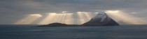 Sunrays behind the island of Koltur Faroe Islands 