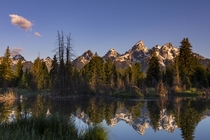 Sunrise on the Tetons reflected in a beaver pond 