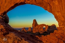 Sunrise through the Window Arches National Park Utah  by Matthew Gehrtz